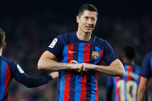 Barcelona’s Robert Lewandowski celebrates after scoring his side’s second goal in the win against Cadiz (Joan Monfort/AP)