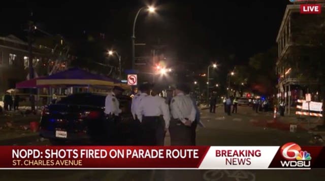 <p>Officers on the parade route where the shooting unfolded on Sunday night</p>