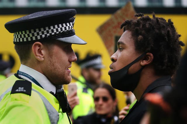 <p>A protester confronts a Police Officer during a Black Lives Matter protest on June 2020 </p>