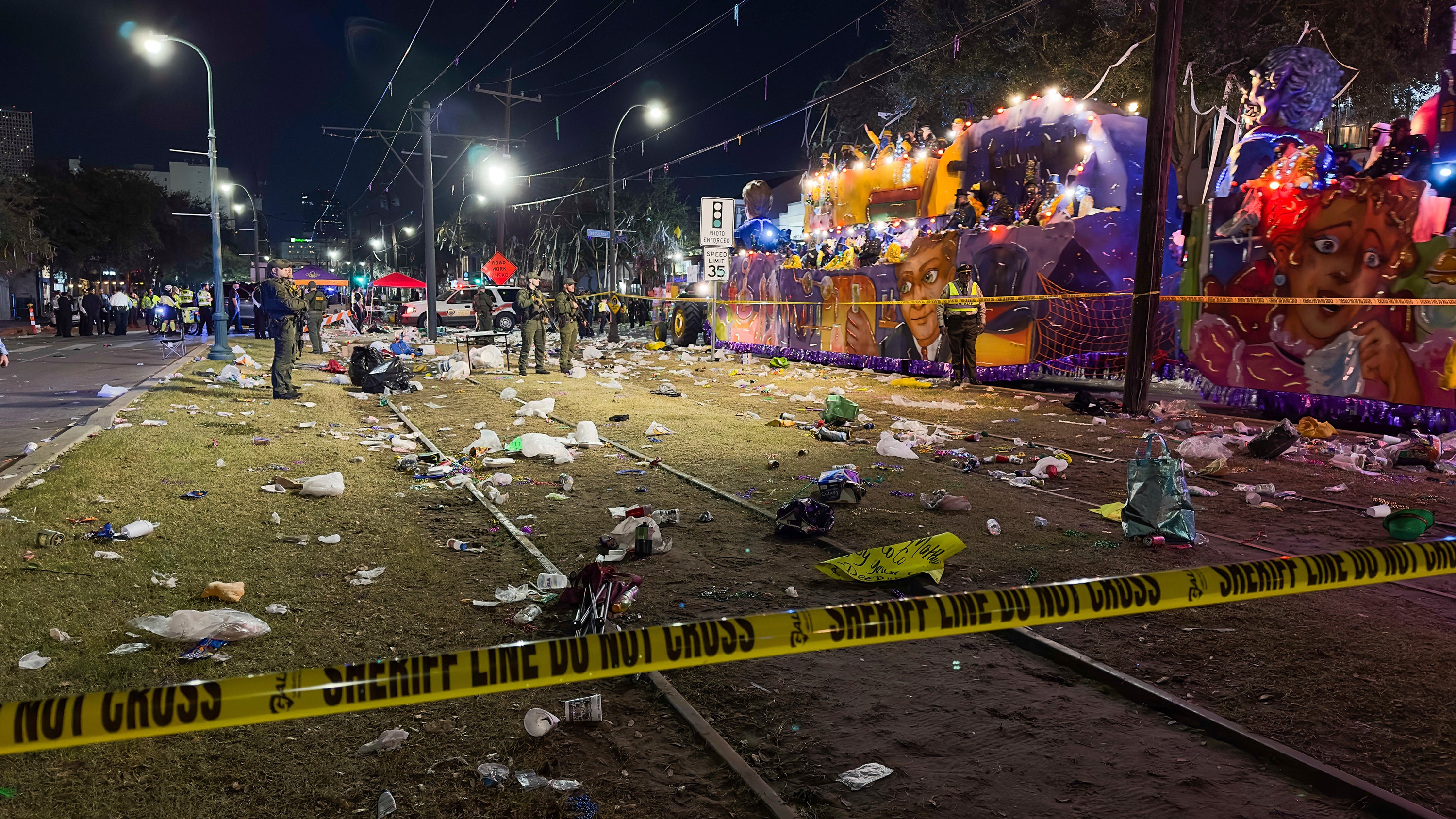 Police work the scene of a shooting at the Krewe of Bacchus parade on Sunday.