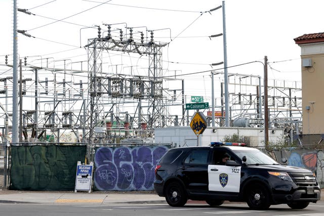 <p>Oakland Police officers block a road near the site of a PG&E substation where a fire earlier in the day caused a power outage throughout much of Oakland, Calif., on Sunday, Feb. 19, 2023. (Carlos Avila Gonzalez/San Francisco Chronicle via AP)</p>