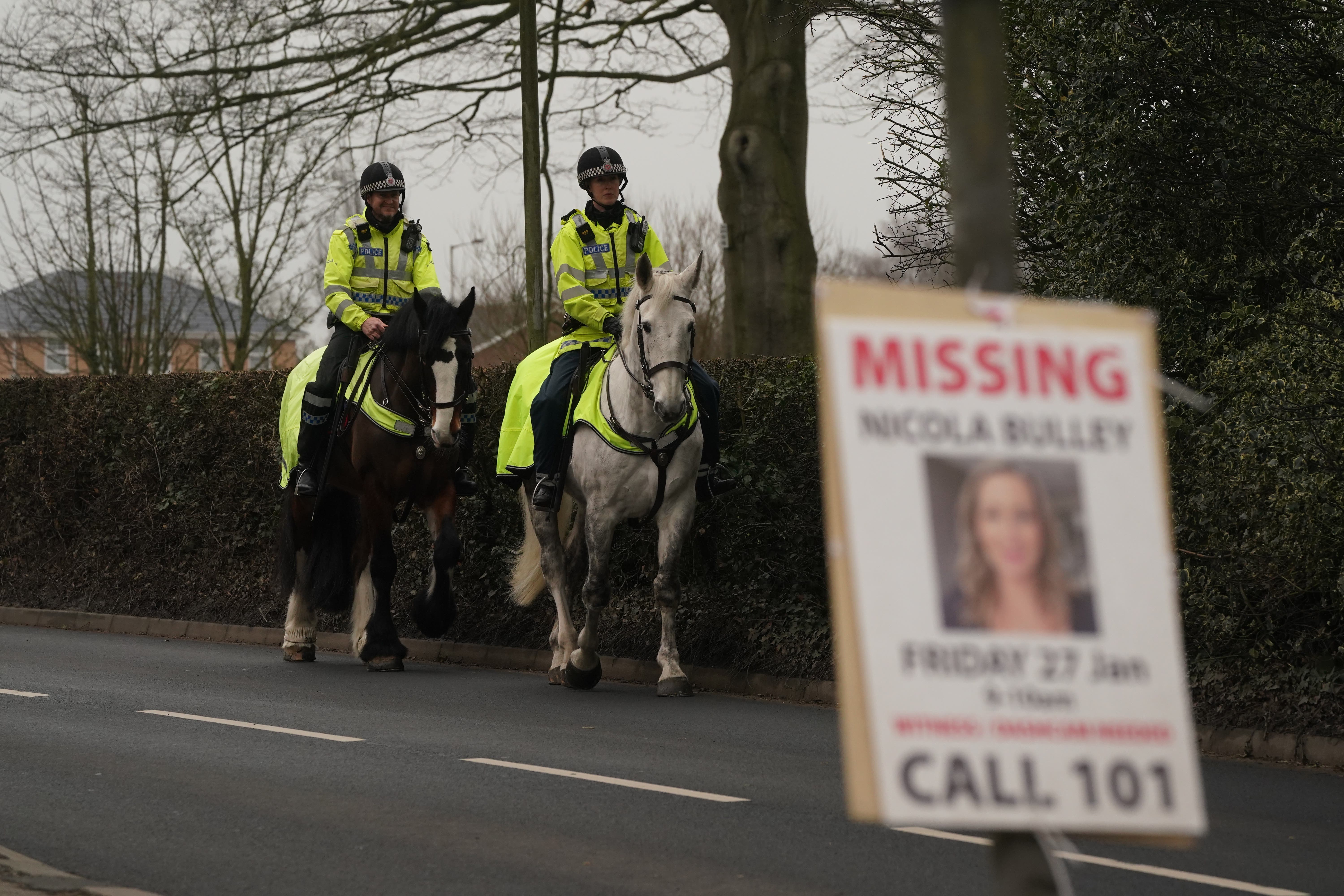 Mounted police officers along the main road in the village of St Michael’s on Wyre, Lancashire (PA)