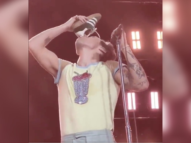 <p>Harry Styles drinking from his shoe during concert</p>