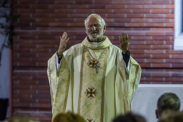 <p>Bishop David O'Connell leads a non-denominational memorial service in 2020 </p>