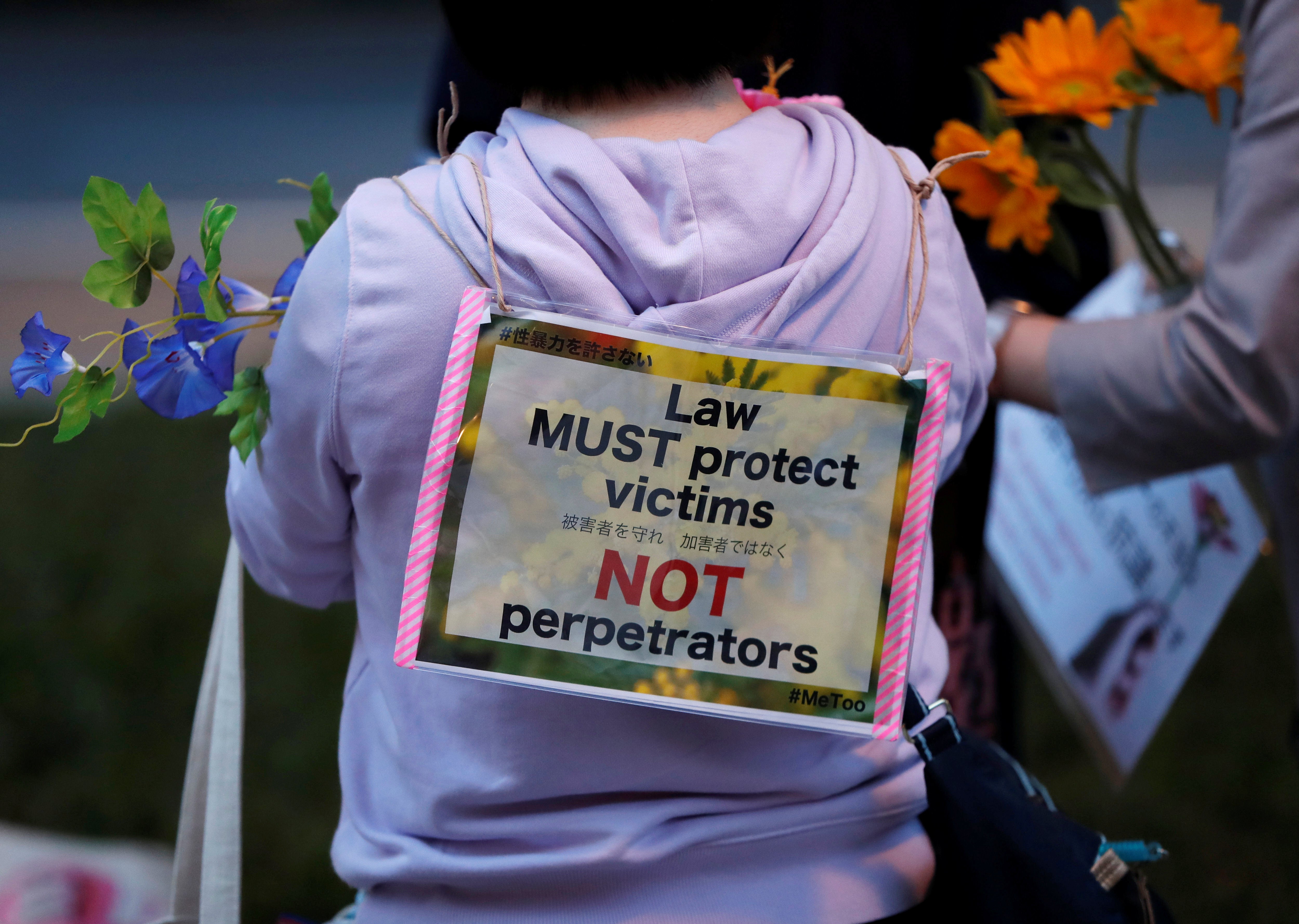 File. Protesters hold fowers at the rally called 'Flower Demo' to criticise acquittals in court cases of alleged rape in Japan in 2019