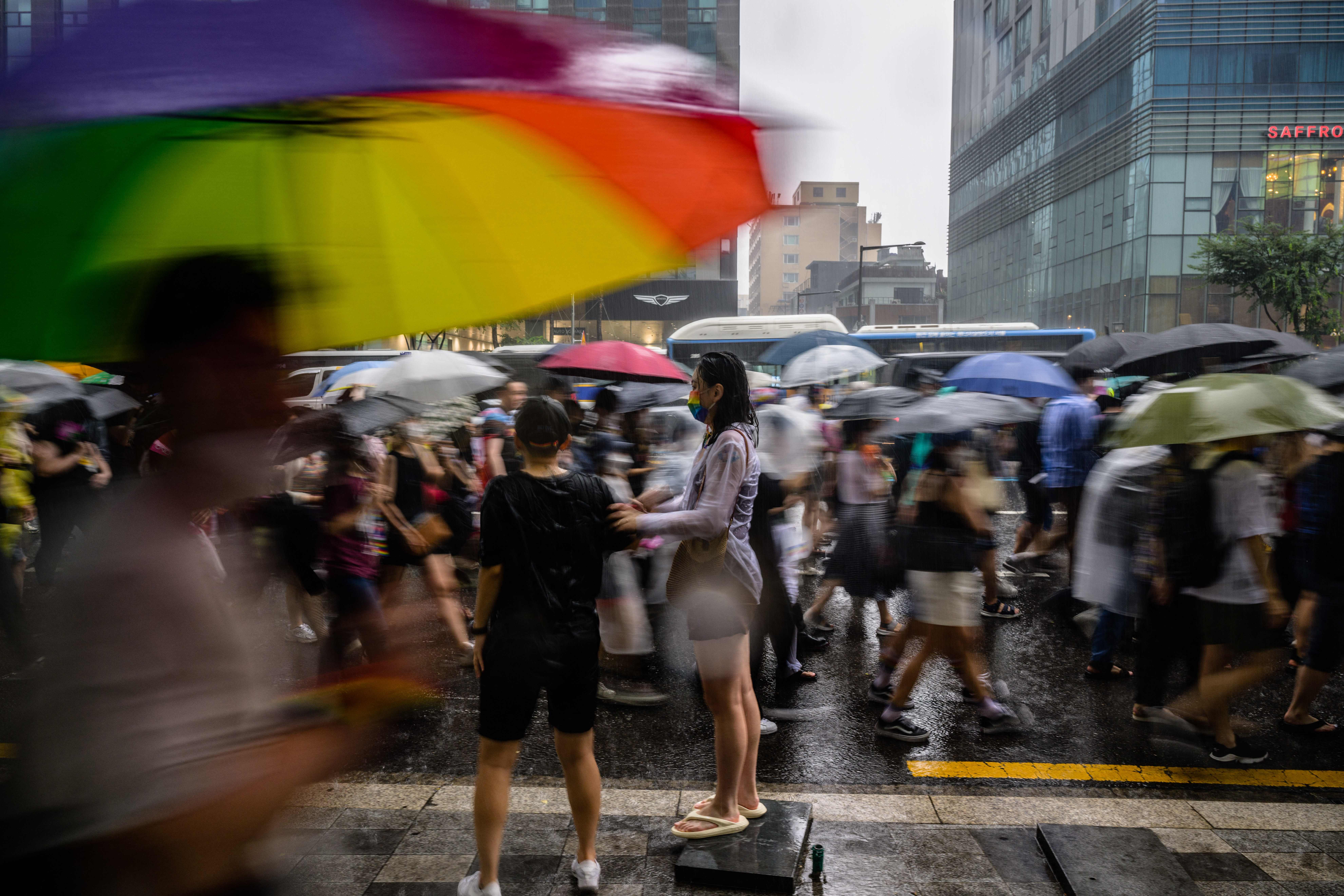 File: Participants take part in a parade as it rains heavily during a Pride event in support of LGBTQ rights as part of the Seoul Queer Culture Festival in Seoul