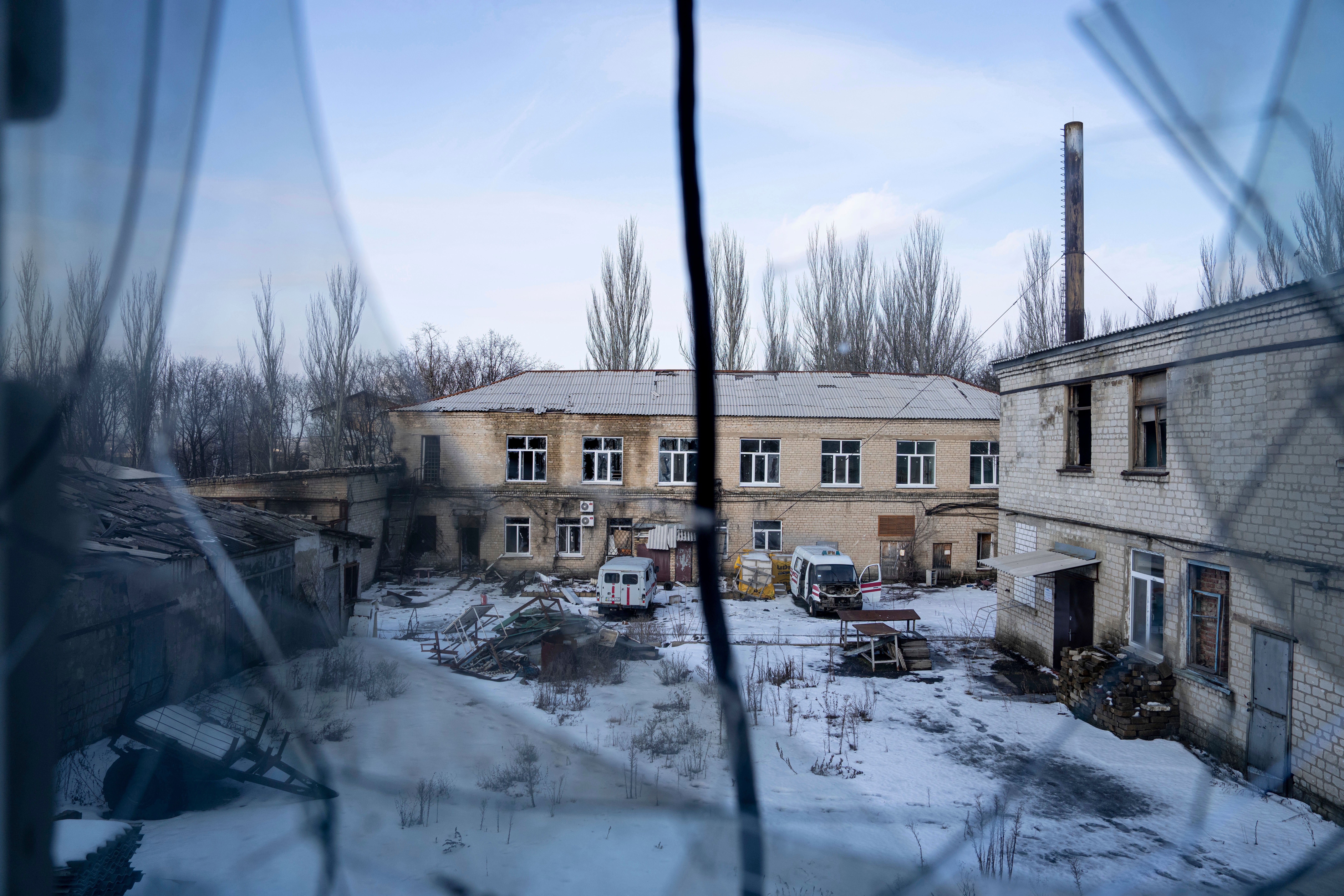 A view of the yard of hospital which was damaged by Russian shelling is seen from a broken window in Krasnohorivka, Ukraine