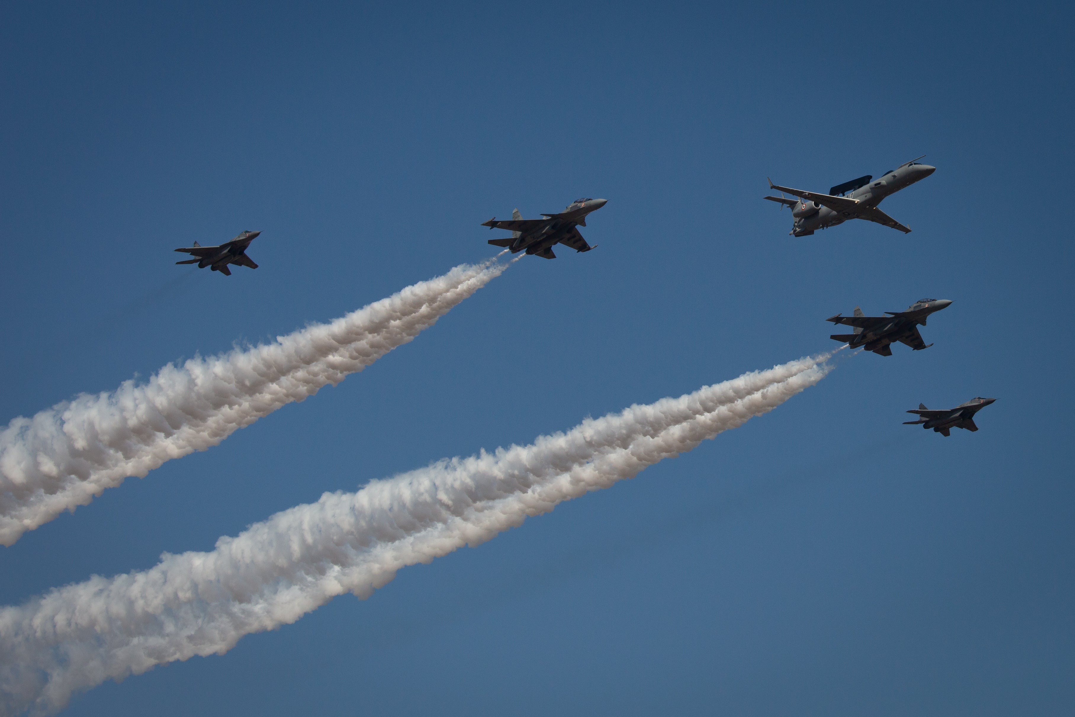 Indian Air Force planes fly in formation during the inauguration of the Aero India 2023 at the Yelahanka Air Force Station in Bengaluru, India