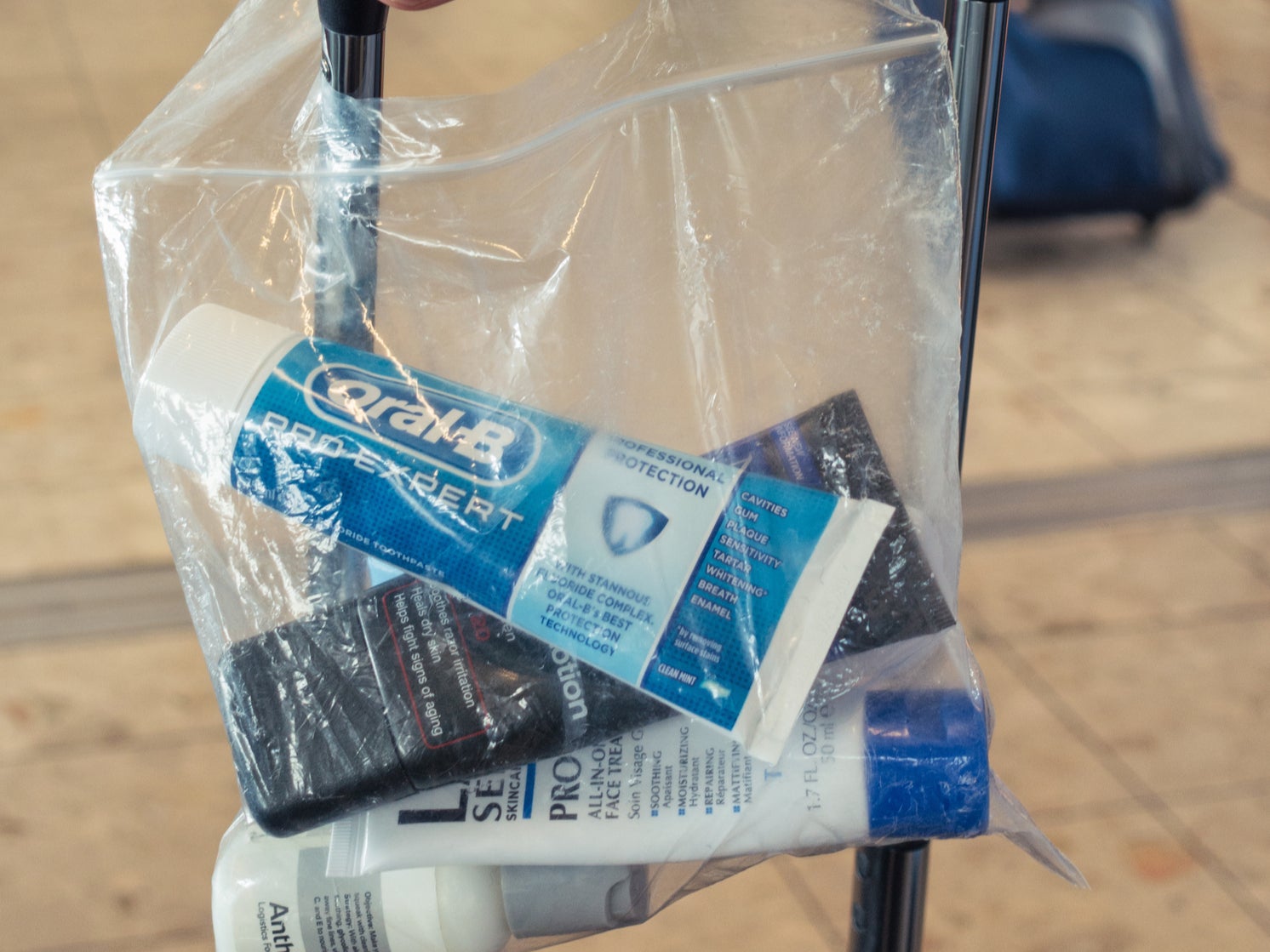 A transparent bag containing small bottles of liquid and gel in compliance with airport security