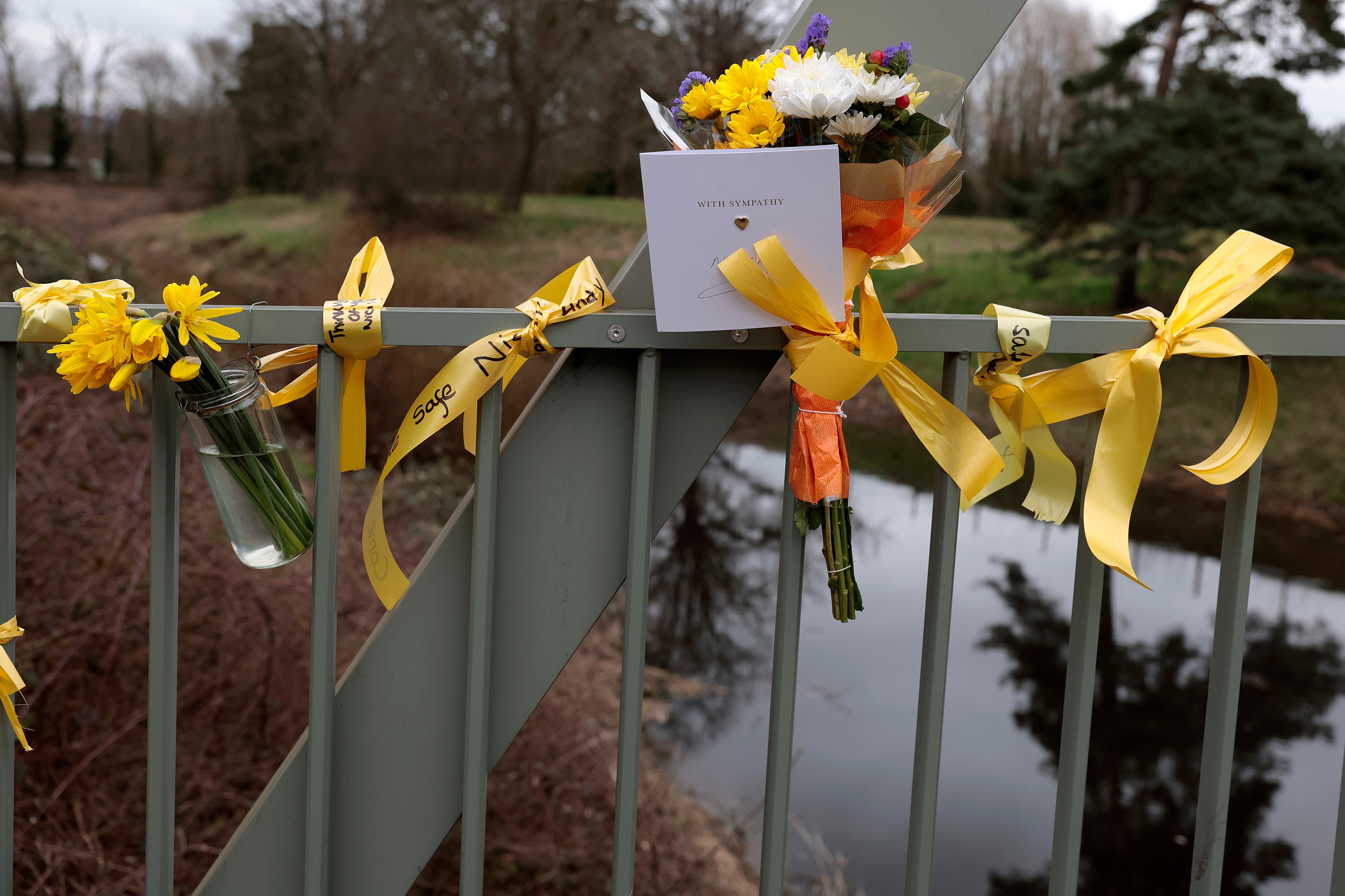 Flowers were left on a footbridge over the River Wyre in tribute
