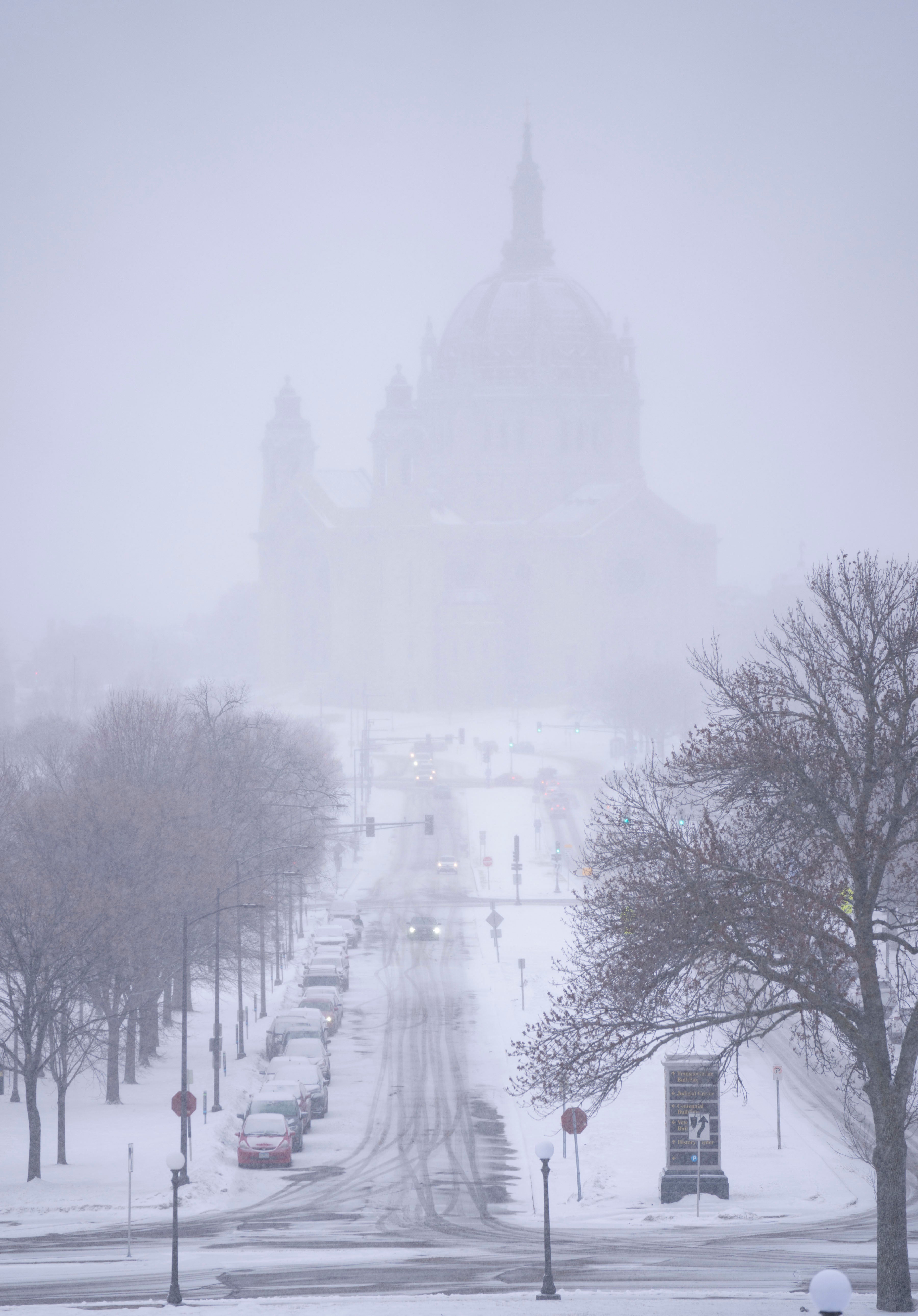 Snow begins to fall around the Cathedral of Saint Paul, on Tuesday, February 21 at the Minnesota State Capitol in St. Paul, Minnesota. A monster winter storm took aim at the Upper Midwest on Tuesday (Alex Kormann/Star Tribune via AP)