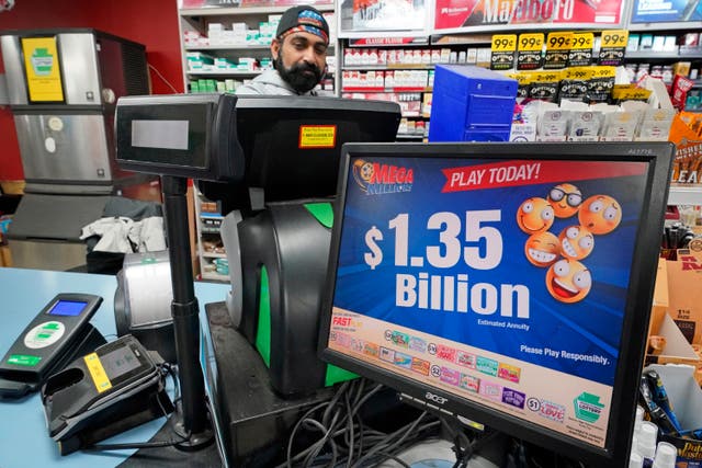 <p>A Mega Million sign displays the estimated jackpot of $1.35bn at the Cranberry Super Mini Mart in Cranberry, Pennsylvania, on 12 January 2023</p>