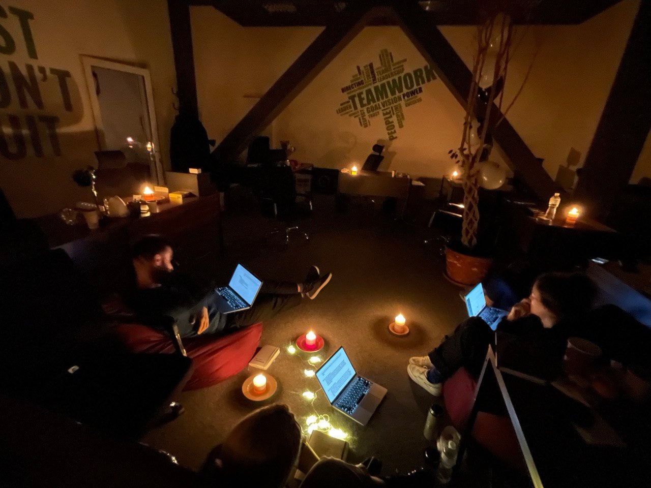 The Kyiv Independent team working by candlelight during a power outage