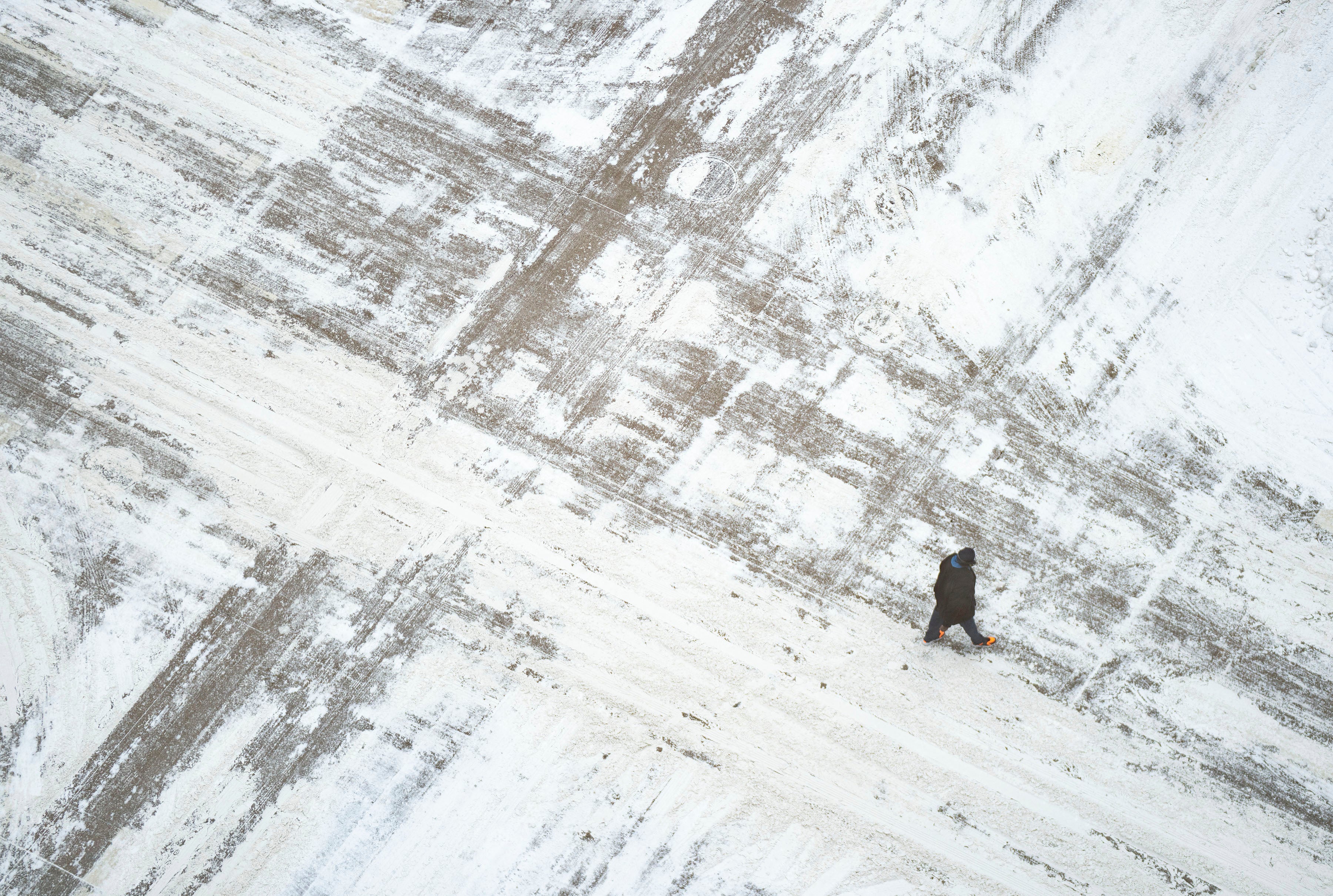 A man crosses a snow covered South Sixth St on Wednesday, February 22 in downtown Minneapolis. (Alex Kormann/Star Tribune via AP)