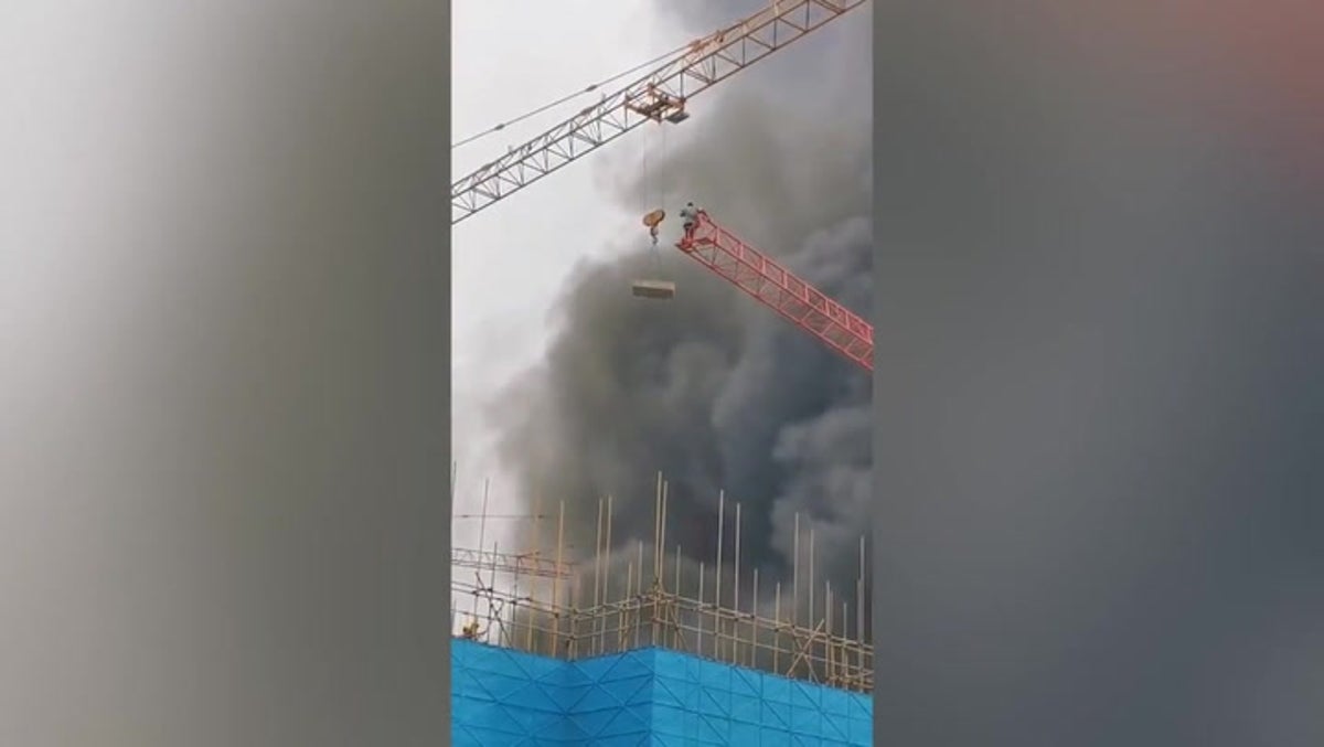 Trapped worker rescued from burning construction site by crane and concrete slab