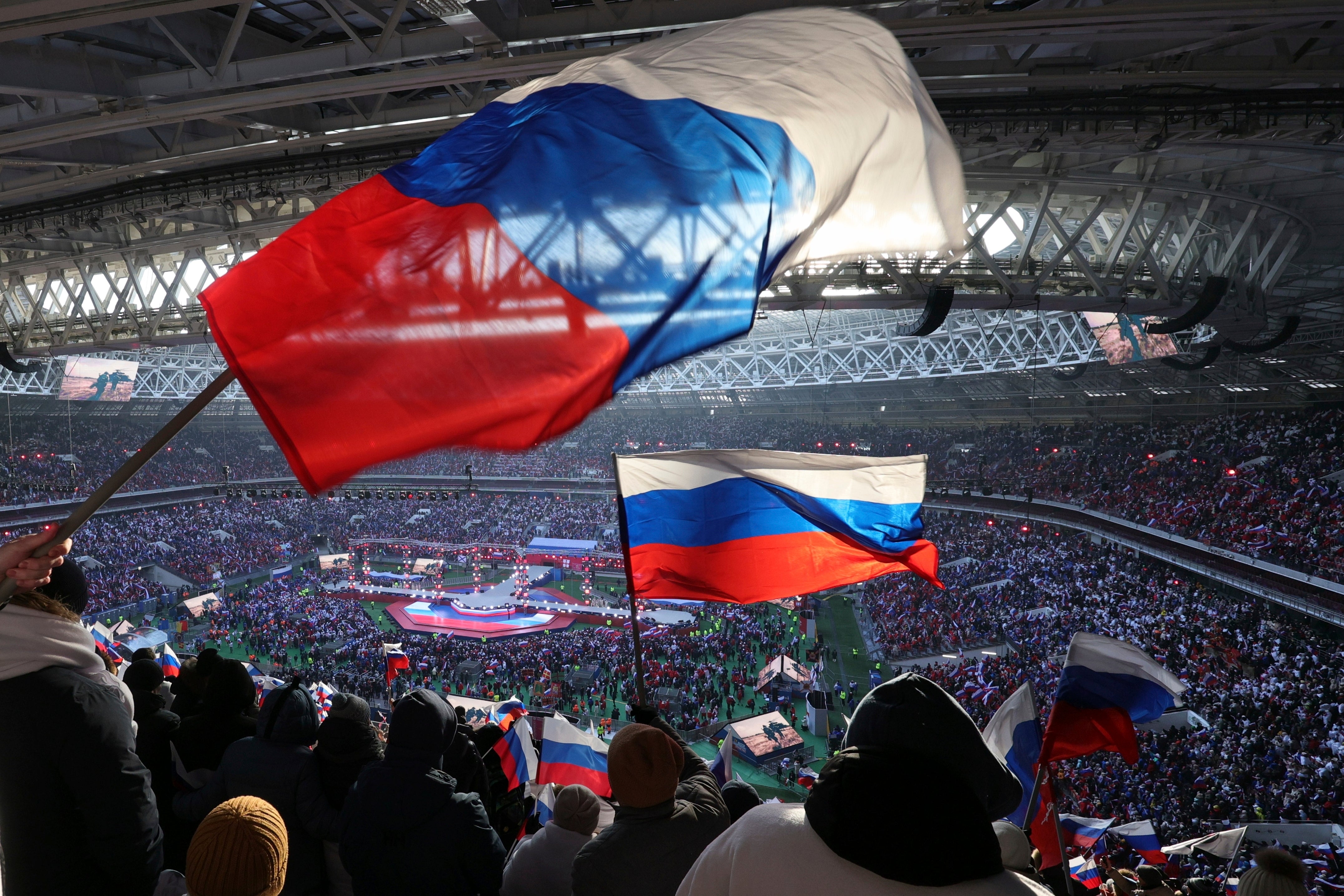 Russian flags are waved at the ‘Glory to the Defenders of the Fatherland’ concert for Vladimir Putin in Moscow