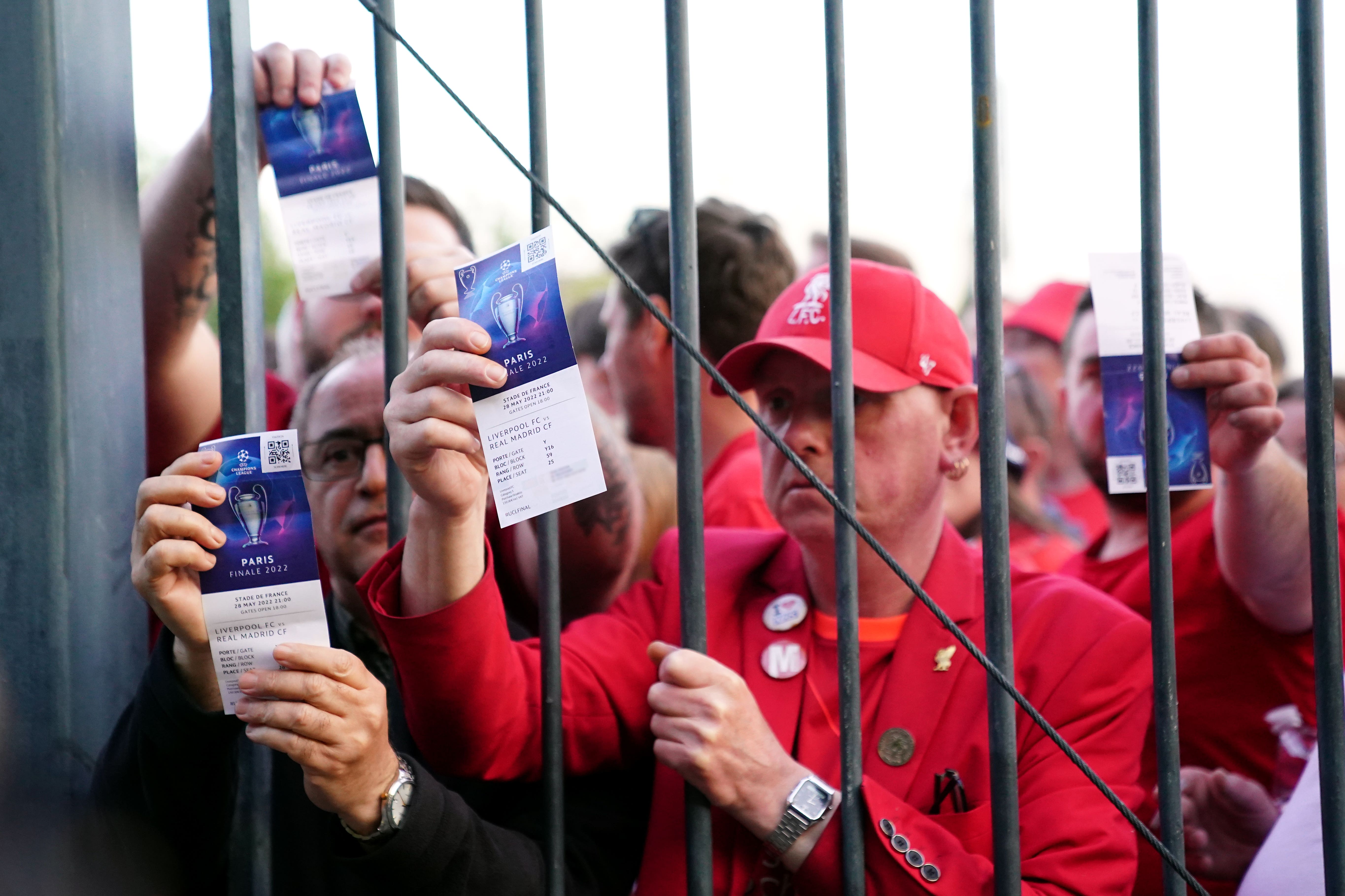 Liverpool fans stuck outside the Stade de France show their match tickets ahead of last season’s Champions League final (Adam Davy/PA)