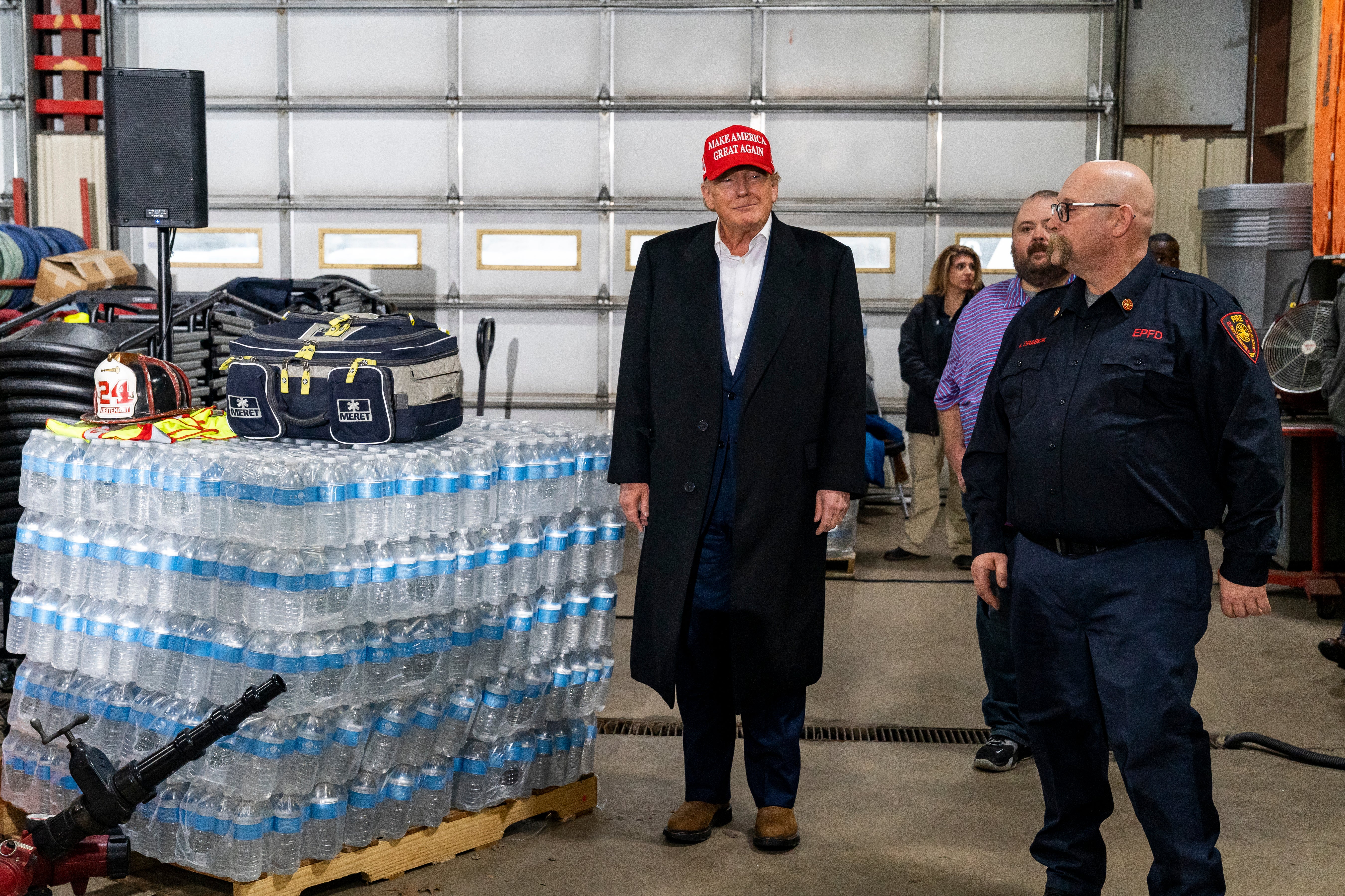 Former President Donald Trump stands next to a pallet of water before delivering remarks at the East Palestine Fire Department station