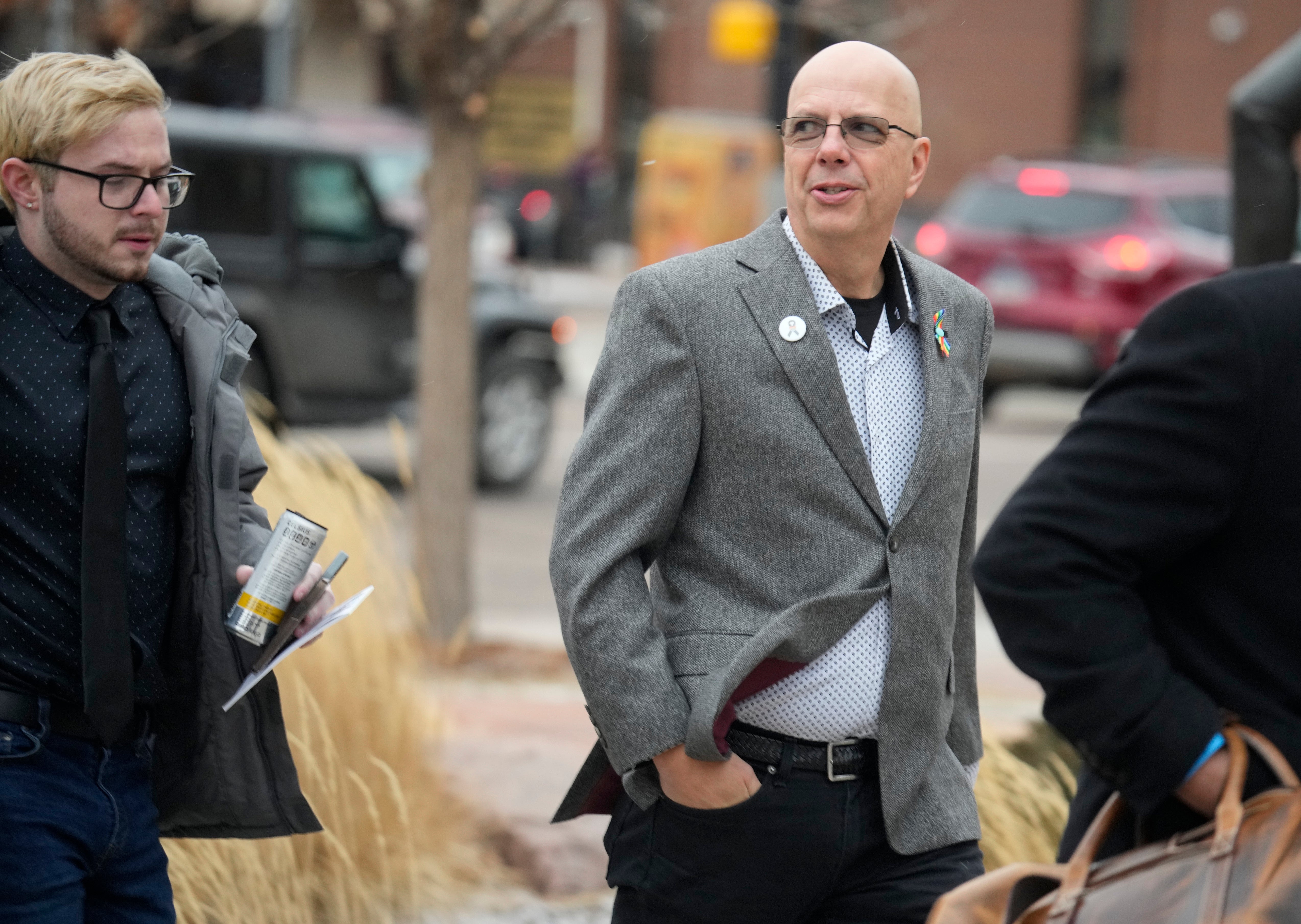Michael Anderson, left, a survivor of the mass shooting at Club Q, walks with the club's co-owner, Matthew Haynes, into the El Paso County courthouse