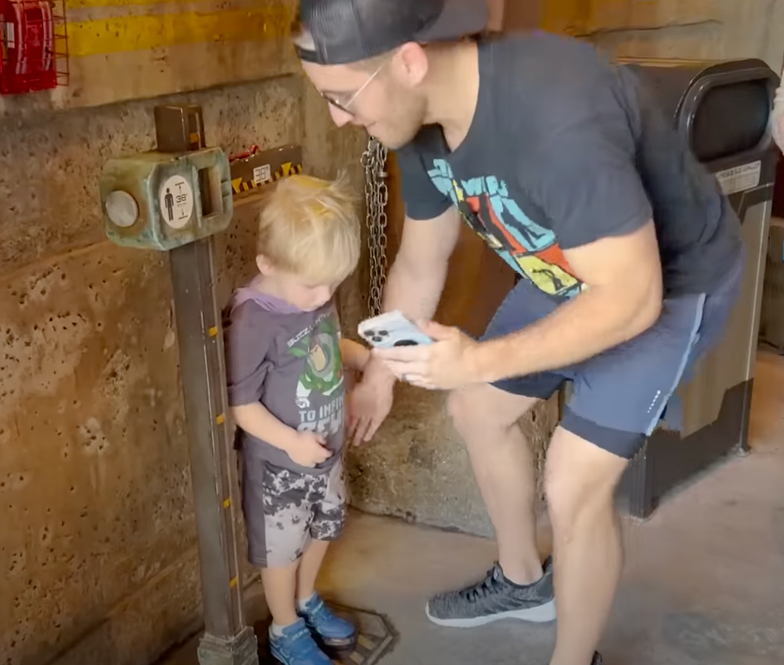 A screenshot of Ty Kelly’s son, Kannon, getting measured at Disney wearing his adapted ‘platform’ shoes