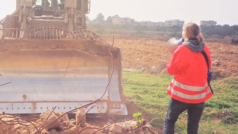 Corrie pictured hours before her death in front of a bulldozer. She and fellow activists were trying to prevent demolition of Palestinian homes