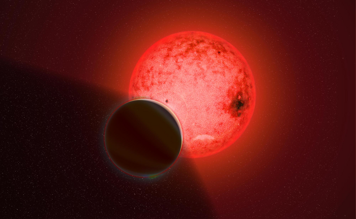 Artist's conception of a large gas giant planet orbiting a small red dwarf star called TOI-5205