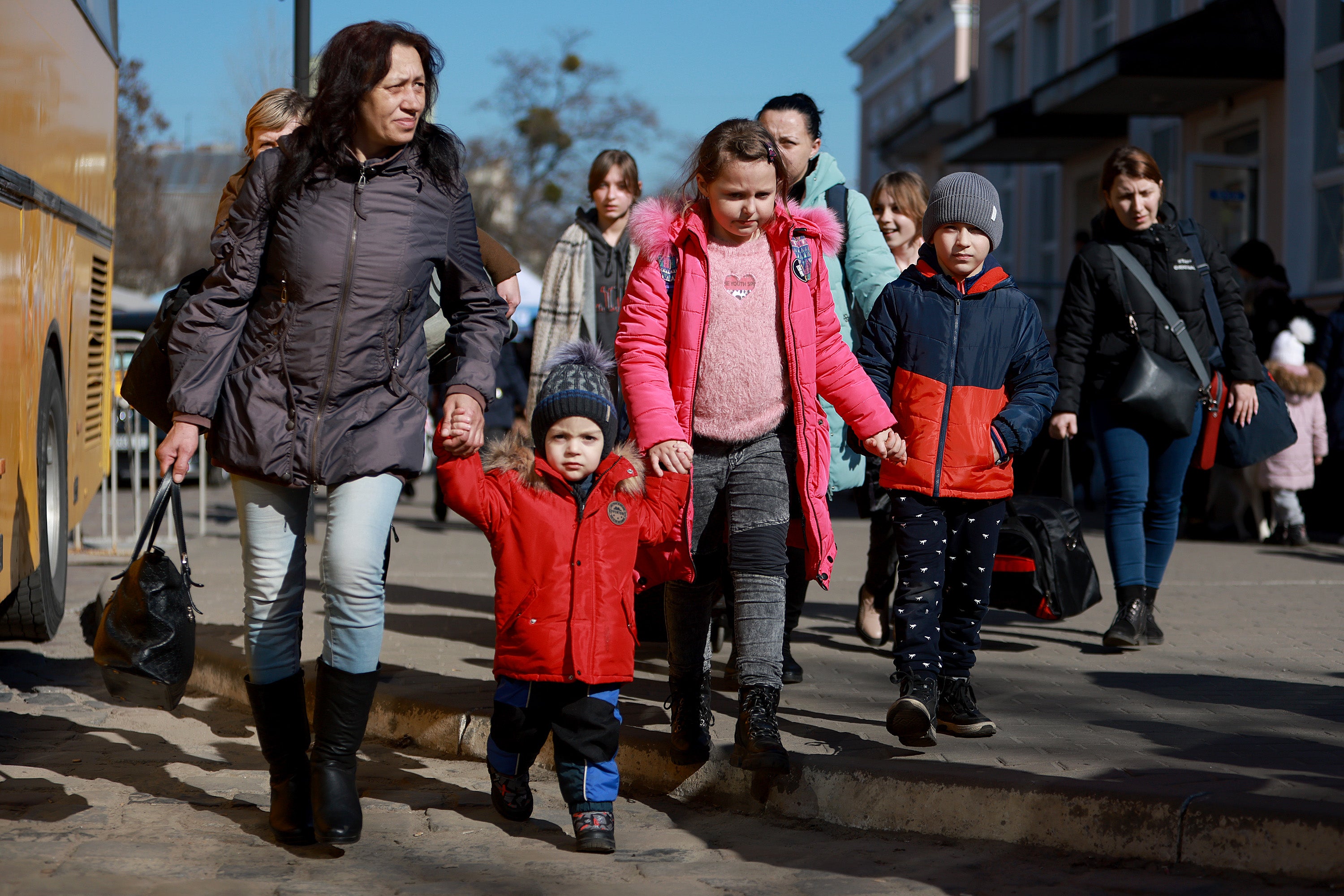 People from the town of Zaporizhzhia walk together after fleeing from their home town on the train
