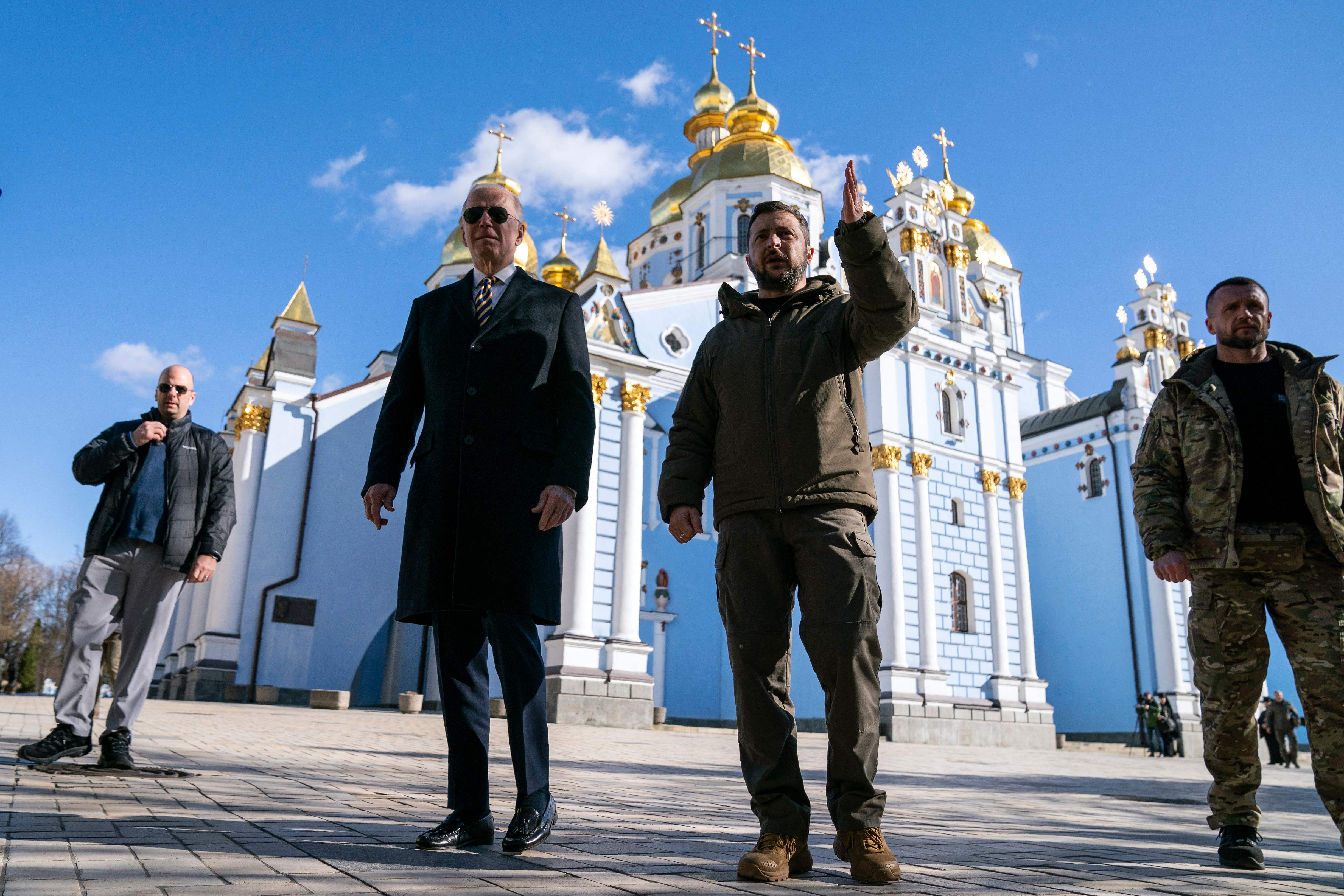 US President Joe Biden walks with Ukrainian President Volodymyr Zelensky at St. Michael's Golden-Domed Cathedral during an unannounced visit, in Kyiv