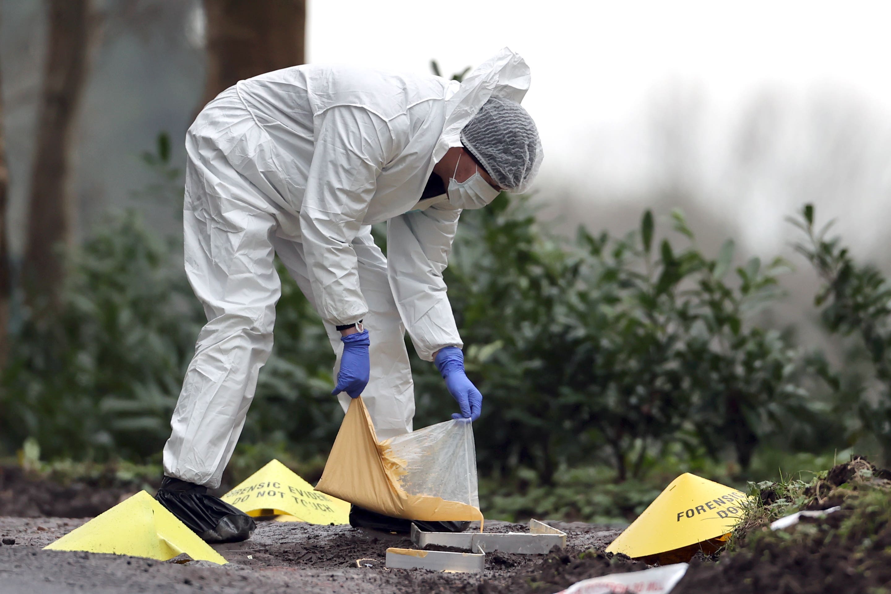 A forensic officer making a mould at the scene near the sports complex in the Killyclogher Road area of Omagh, Co Tyrone