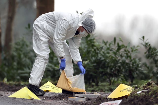 <p>A forensic officer making a mould at the scene near the sports complex in the Killyclogher Road area of Omagh, Co Tyrone</p>