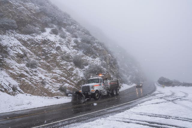 <p>A snow plow truck drives along the Angeles Forest Highway near La Canada Flintridge, California on Thursday, Feb. 23, 2023. For the first time since 1989, the National Weather Service issued a blizzard warning for the Southern California mountains (AP Photo/Jae C. Hong)</p>