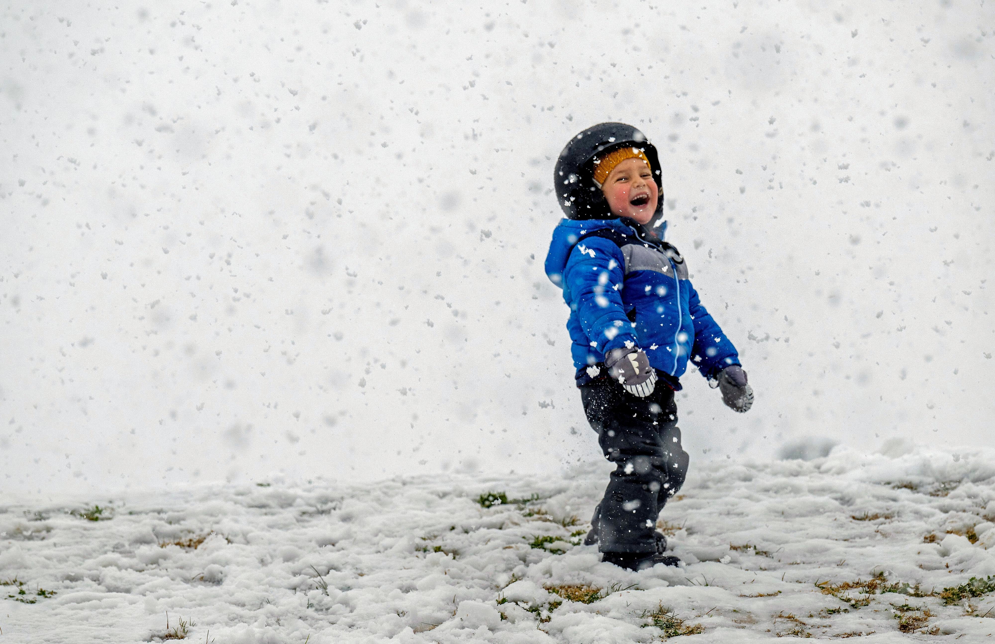 Kamal Rahm, aged three, of Carlsbad, enjoys the snow at Yucaipa Community Park in California, on Thursday (Terry Pierson/The Orange County Register via AP)