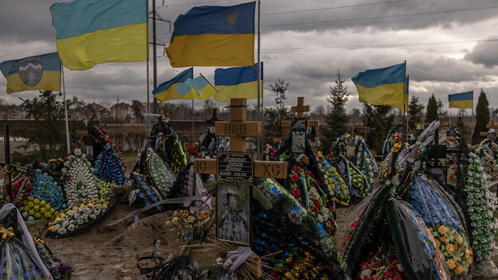 Ukrainian flags wave over the graves of Ukrainian soldiers killed during the Russian invas...