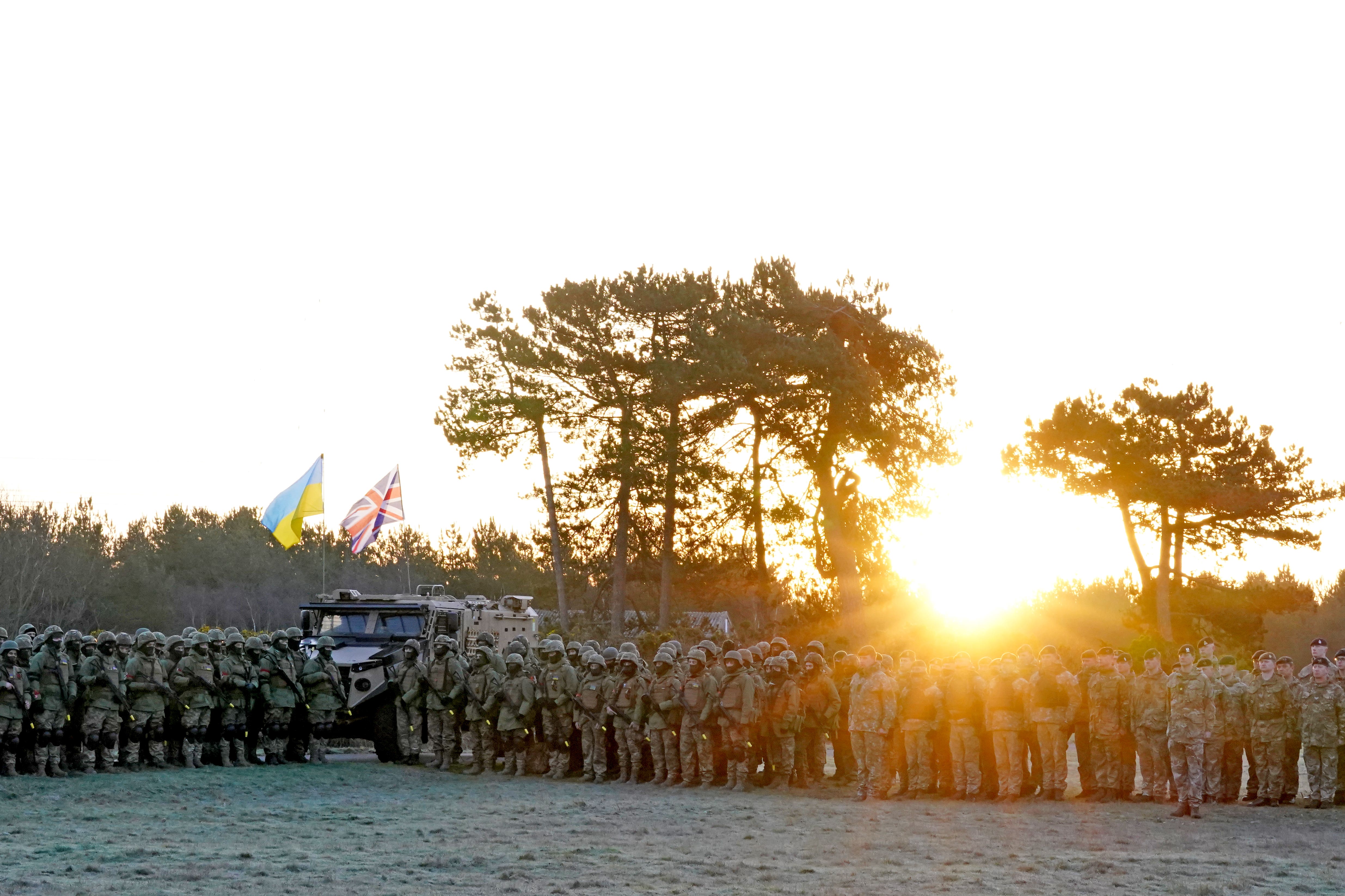 Ukrainian troops and their UK military instructors commemorate lives lost in the Russian invasion of Ukraine during a sunrise commemorative service at an Army camp in the South East to mark the one-year anniversary of the start of the conflict (Gareth Fuller/PA)