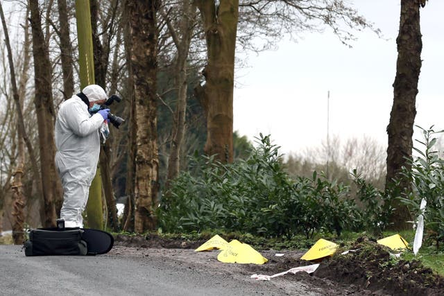 A forensic officer at the scene near the sports complex in the Killyclogher Road area of Omagh, Co Tyrone, where off-duty PSNI Detective Chief Inspector John Caldwell was shot (Liam McBurney/PA)
