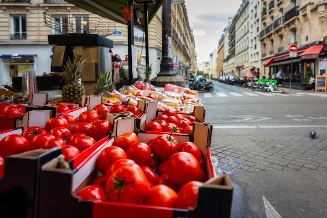 <p>Tomatoes on display in a Parisian street market</p>