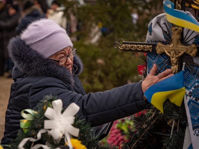 <p>An elderly resident of Bakhmut cries as she marks the anniversary of Russia’s invasion of Ukraine</p>