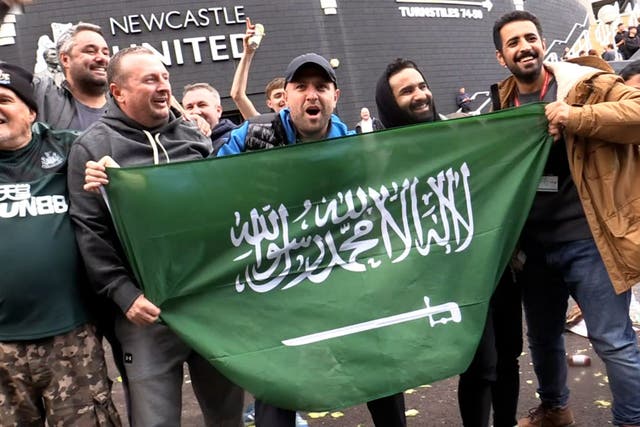 Newcastle supporters celebrate the Saudi-led takeover of the club in October 2021 (Tom Wilkinson/PA)