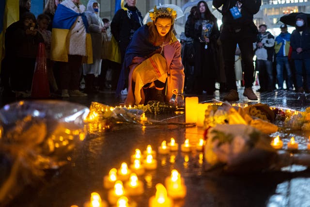 <p>People take part in a candlelight vigil outside UN University to mark the one year anniversary of the Russian invasion of Ukraine, in Tokyo</p>