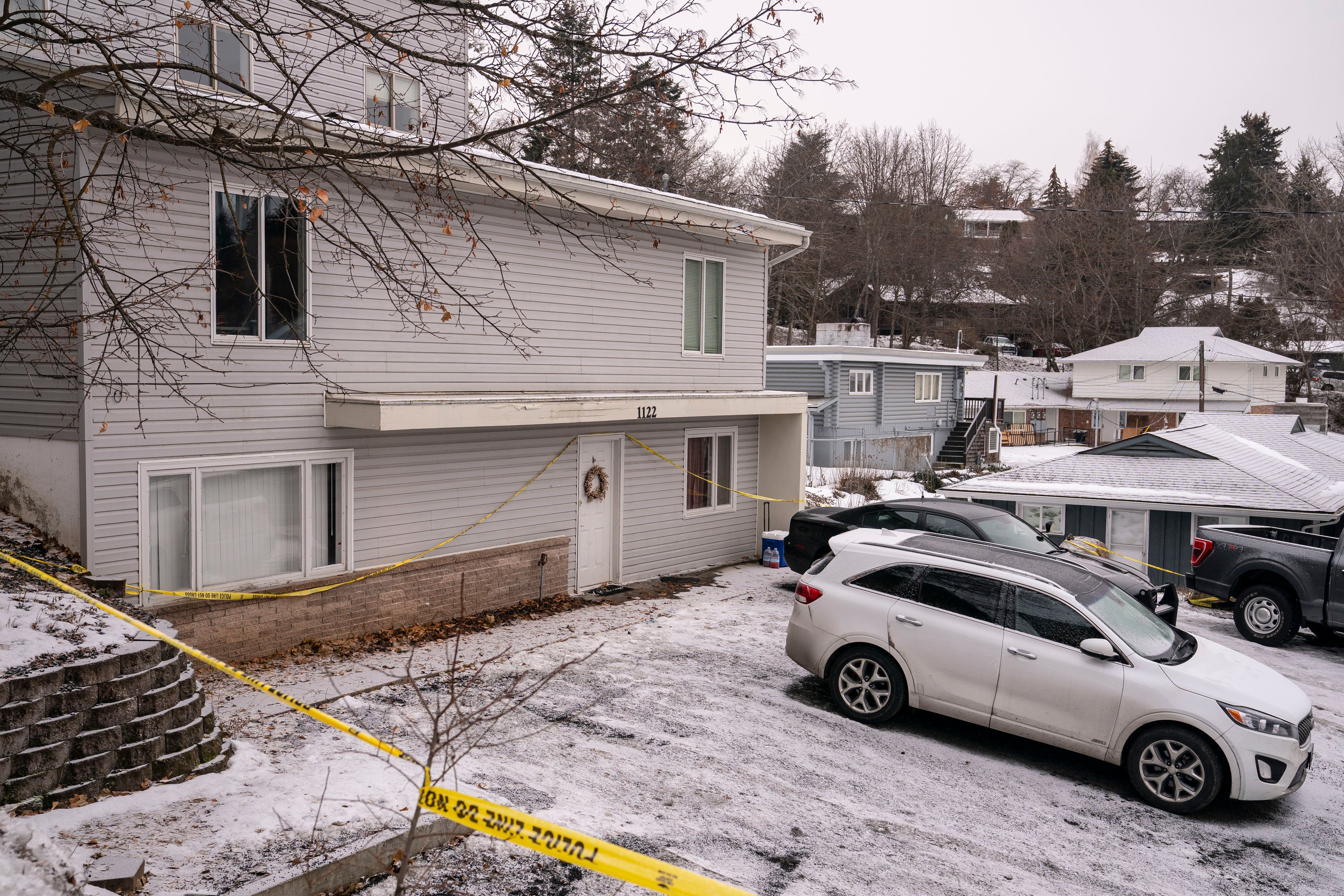 Police tape surrounds the home where the four students were killed