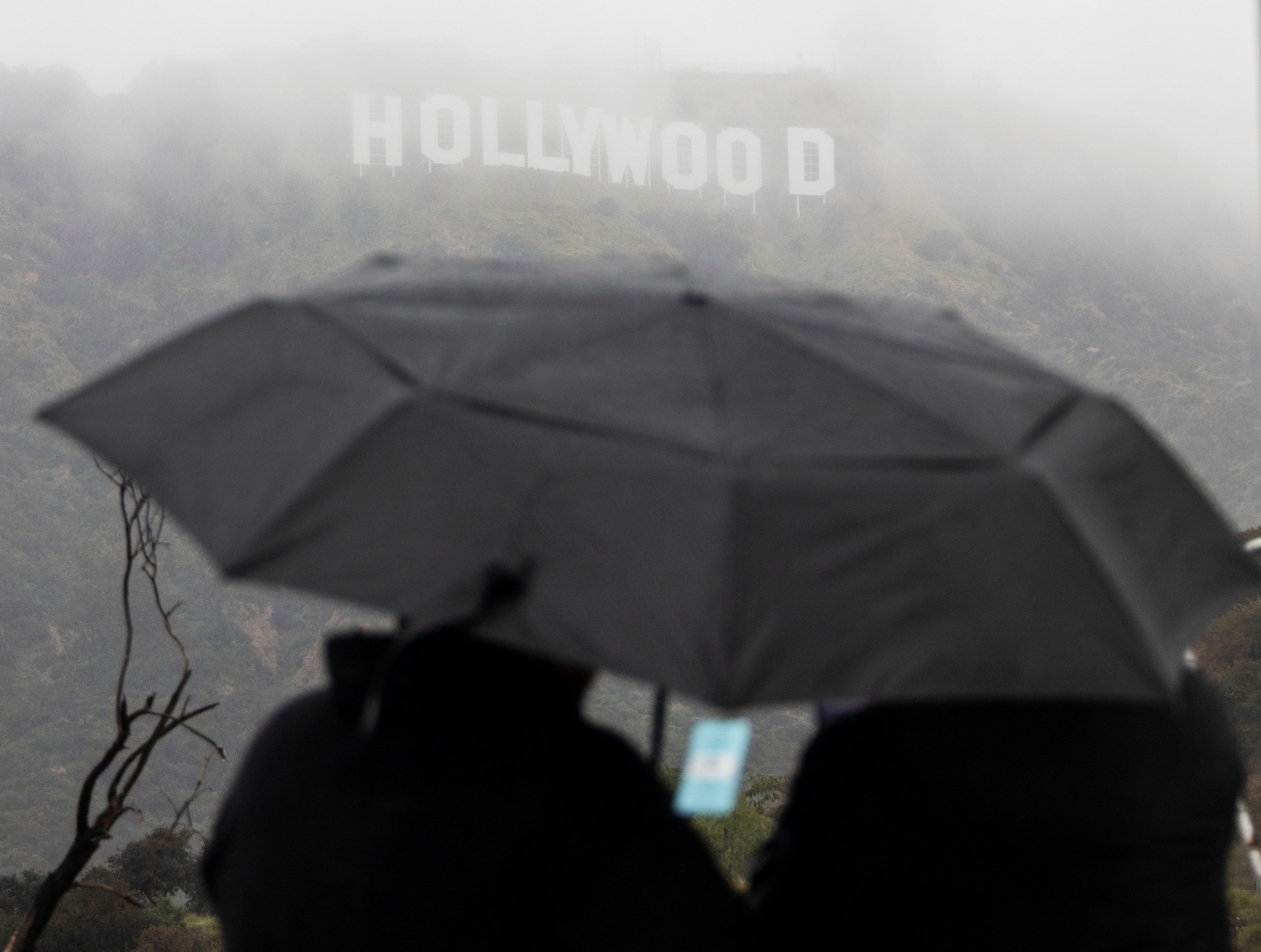 Southern California shivers in blizzard conditions as tornadoes threaten LA and 114,000 without power
