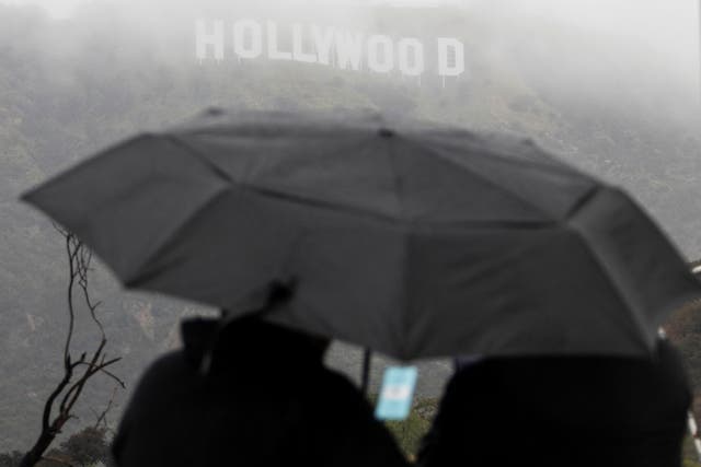 <p>Visitors come to look at the Hollywood sign during a rare cold winter storm in the Los Angeles area, in Los Angeles, California, U.S., February 24, 2023</p>