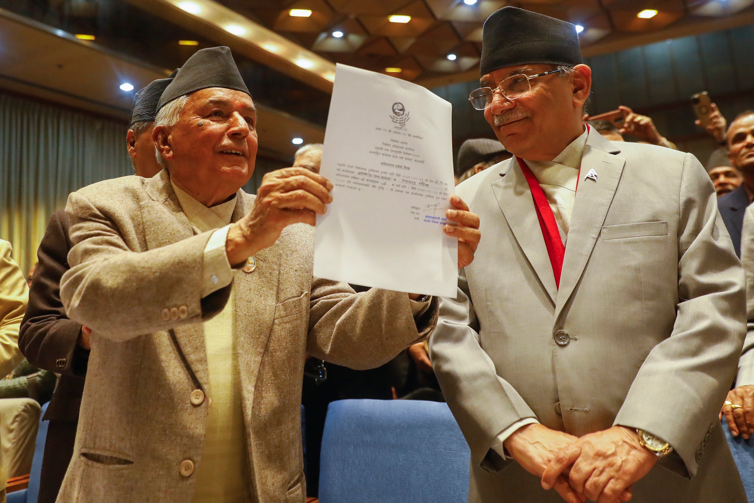 File. Nepalese Prime Minister Pushpa Kamal Dahal, right, looks on as Ram Chandra Poudel of the Nepali Congress party, left, shows his candidacy papers after filling his nomination to become Nepal's next president as in Kathmandu, Nepal, Saturday, 25 February 2023