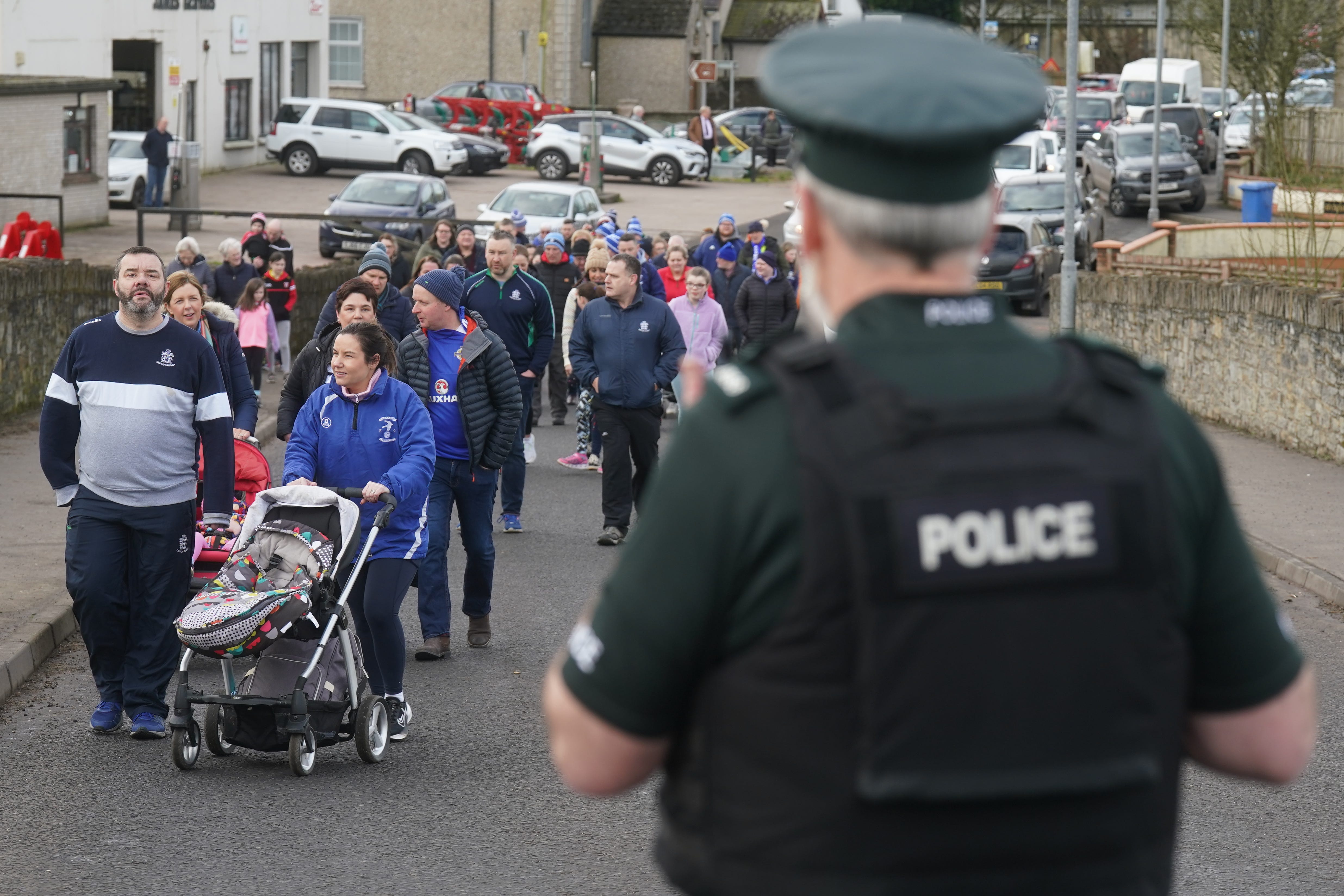 Club members and supporters taking part in a walk of solidarity from Beragh Swifts clubhouse after the shooting of Detective Chief Inspector John Caldwell (Brian Lawless/PA)