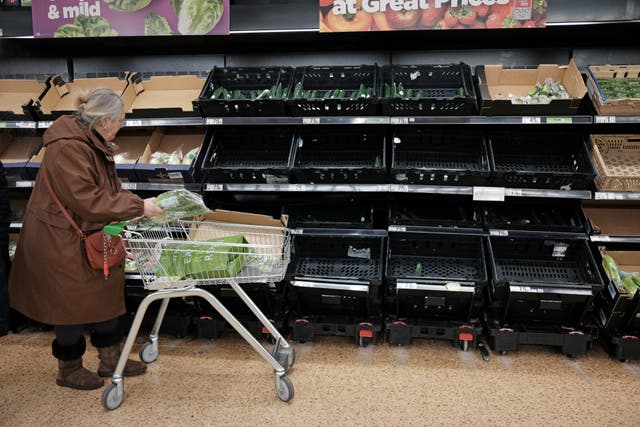 Empty fruit and vegetable shelves at an Asda in east London (PA)