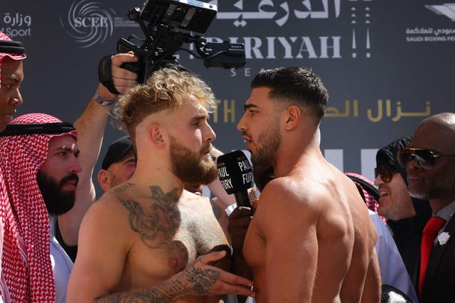 <p>Tommy Fury and Jake Paul face off during the weigh-in event</p>
