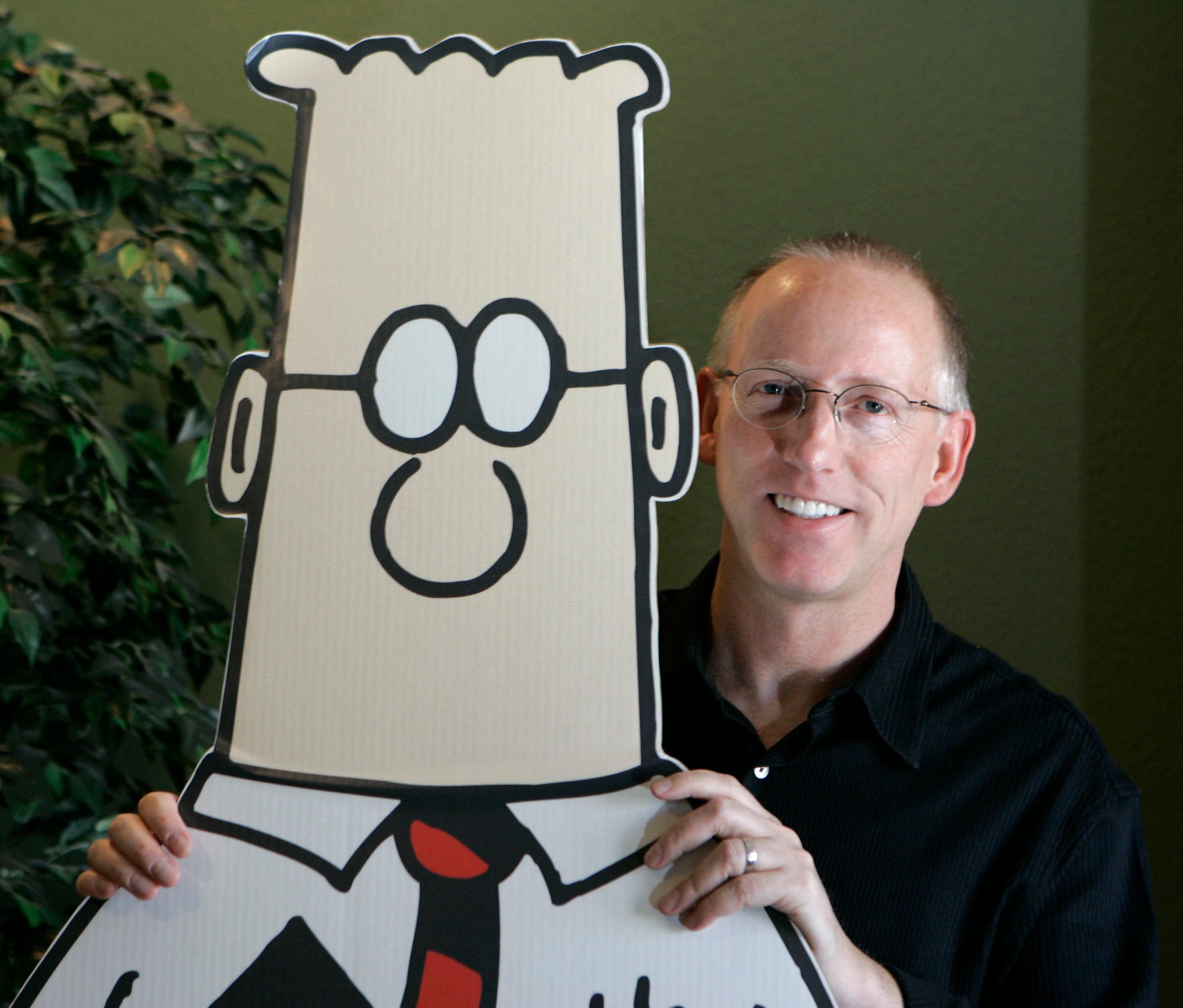 Adams holding a Dilbert cut-out