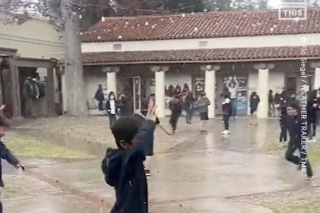 <p>Second graders in Pasadena enjoy a hail storm brought by a massive weather system that blanketed California in snow and heavy rains</p>