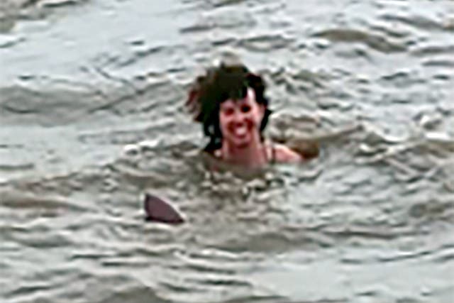 <p>Claire Bye swimming with a dolphin in a river in Santa Rosa de Yacuma, Bolivia</p>