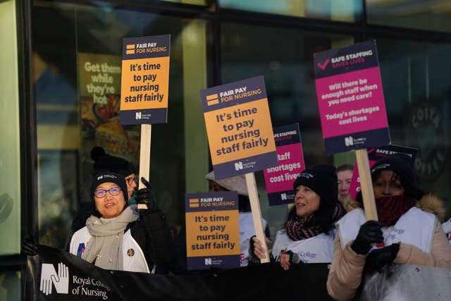 Workers on the picket line outside Queen Elizabeth hospital in Birmingham (Jacob King/PA)